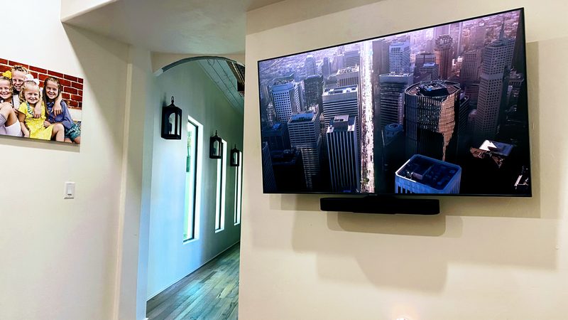 Large TV wall mount with soundbar installed by Onora Systems in Tucson home